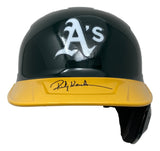 The Sports Integrity Rickey Henderson Signed Oakland A's Full Size Replica Batting Helmet features the team's green and yellow colors, an "A's" logo on the front, and Rickey Henderson's signature across the yellow brim.