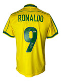 A yellow Brazil Nike soccer jersey by Sports Integrity, featuring green trim, RONALDO and number 9 with a signature on the back. Authenticated as the Ronaldo Signed Brazil Nike Soccer Jersey BAS.