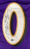 The Sports Integrity Roquan Smith Baltimore Signed Purple Football Jersey (BAS ITP) features a large white and gold-outlined number zero with Smith’s black marker signature on it and an authentication sticker below.