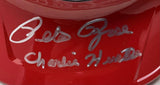 A Pete Rose Signed Cincinnati Reds full-size batting helmet by Sports Integrity features a red surface and a silver "Lets Go Charlie Hustle" inscription.