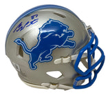 The Sam LaPorta Signed Detroit Lions Mini Speed Helmet by Sports Integrity features a silver finish, blue lion logo, blue faceguard, and a dark blue autograph on top.
