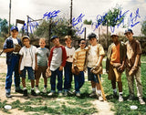 The Sandlot Cast Signed 16x20 Photo by Sports Integrity features nine boys on a sunny baseball field, smiling and holding gloves or bats, with grass, trees, and a fence in the background. Includes Patrick Renna, Tom Guiry & 6 others. JSA authenticated.