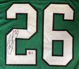 The Sports Integrity Saquon Barkley Philadelphia Kelly Green Football Jersey features a large white #26 outlined in black, autographed in black marker on the left side with a BAS authentication sticker below the signature.