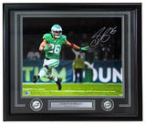 Sports Integrity Saquon Barkley Signed Framed 16x20 Eagles Kelly Green Photo (BAS 2W539596) features Barkley in a green uniform, running on the field, with a name plaque and two Philadelphia Eagles logos.