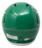 The PRE ORDER Saquon Barkley Signed Eagles Full Size Kelly Green Replica Speed Helmet by Sports Integrity features rear air vents, a circular white logo on top, and a warning label with safety info at the bottom edge.