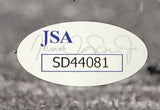 A close-up of the JSA SD44081 authentication sticker with a faded signature is shown on the Sports Integrity Saquon Barkley Signed Framed 8x10 Penn State Nittany Lions Photo. JSA appears in blue letters above the code.