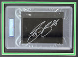 The Sports Integrity Saquon Barkley Signed Framed Cut Sig features a bold white autograph, PSA/DNA authentication, and an 8x10 Eagles reverse hurdle photo, all set in a sleek green and black double-layered mat frame.