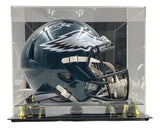 The Sports Integrity Saquon Barkley Signed Philadelphia Eagles FS Replica Speed Helmet is showcased in a clear acrylic case with a black and gold base.