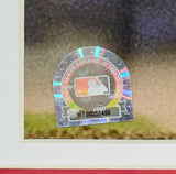 A close-up of the MLB authentication hologram sticker with serial number MT00359496 on a Sports Integrity Scott Rolen Signed Framed 16x20 St. Louis Cardinals Photo, with a blurred background.