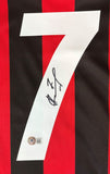 The Sports Integrity Andriy Shevchenko Signed AC Milan Adidas Soccer Jersey features red and black stripes, a large white number 7 with Shevchenko's signature in black marker, and a small circular sticker with logo near the number.