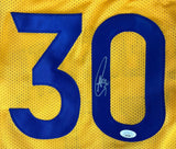 The Sports Integrity Stephen Curry Golden State Signed Yellow Basketball Jersey features a large blue number 30, Curry’s autograph on the zero, and a JSA authentication sticker near the bottom.