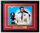 The Sports Integrity Steve Young Signed Framed 11x14 San Francisco 49ers Hall Of Fame Photo (BAS) features him in a cream jacket by his bronze bust, with plaque and blue sky background.