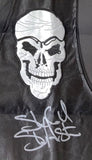 The Sports Integrity Stone Cold Steve Austin Signed Autographed Framed WWE S.O.B Vest BAS features a black leather design, a large skull patch, and Steve Austin's silver autograph below the patch.