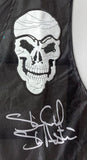 The Stone Cold Steve Austin Signed Framed WWE SOB Vest 2 by Sports Integrity features black fabric with a white embroidered skull and a large white autograph below it.