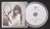 A Taylor Swift Signed Framed TTPD Insert with a 13x19 litho signed by Tony Santiago from Sports Integrity is shown, featuring PSA+SI authentication. Taylor appears in a light top next to the framed artwork with the TS logo.