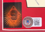 A close-up of a Sports Integrity Beckett-authenticated sticker (code AC66414, QR code) on a Ted Williams Signed Framed 11x13 Red Sox Vintage Moxie Soda Metal Sign BAS LOA, shown beside an orange "9" sticker on a red background.