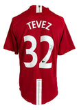 The Sports Integrity Carlos Tevez Signed Manchester United Nike Soccer Jersey BAS is a red jersey featuring "TEVEZ" and number 32 in white, with a vertical white stripe and Tevez's autograph on the number.
