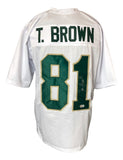 The Sports Integrity Tim Brown Notre Dame Signed White Football Jersey features “T. BROWN” above green-and-gold number 81, signed in silver ink. BAS authenticated.