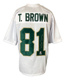 A Tim Brown Notre Dame signed white football jersey by Sports Integrity features green and gold accents, his name and number 81 on the back, with the number autographed in white ink.