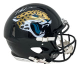 The Sports Integrity Travis Hunter Signed Jacksonville Jaguars Full Size Authentic Speed Helmet BAS features a black helmet with a snarling jaguar logo, black face mask, white chin strap, and Travis Hunter's autograph on the crown.