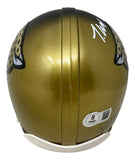 The Sports Integrity Travis Hunter Signed Jacksonville Jaguars Dual Colored Mini Helmet BAS features a jaguar logo on each side, a white autograph on top, and an authentication sticker at the back.