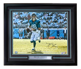 Sports Integrity Trevor Lawrence Signed Framed 16x20 Jacksonville Jaguars Photo by Fanatics, featuring the quarterback running with the football and his nameplate displayed below the image.