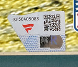 A close-up of a Sports Integrity security sticker on a Trevor Lawrence Signed Framed 16x20 Jacksonville Jaguars Photo Fanatics, featuring code KF50405083, red logo, QR code, blue wavy lines with triangles, and holographic R label.