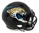 The Sports Integrity Trevor Lawrence Signed Jacksonville Jaguars Mini Speed Helmet features a black design with the jaguar logo and a teal autograph on the top left side.