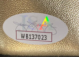 A Mike Tyson signed right hand gold Cleto Reyes boxing glove by Sports Integrity features a white oval JSA authentication sticker with holographic A and code WB137023 on its textured gold surface.