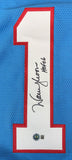 A blue Sports Integrity jersey features a large white number 1 outlined in red, signed by Warren Moon with "HOF 06" inscription.