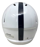 The Tyler Warren Signed Penn State Full Size Speed Replica Helmet by Sports Integrity features a white design with a central dark stripe and a warning label near the bottom, viewed from the back.